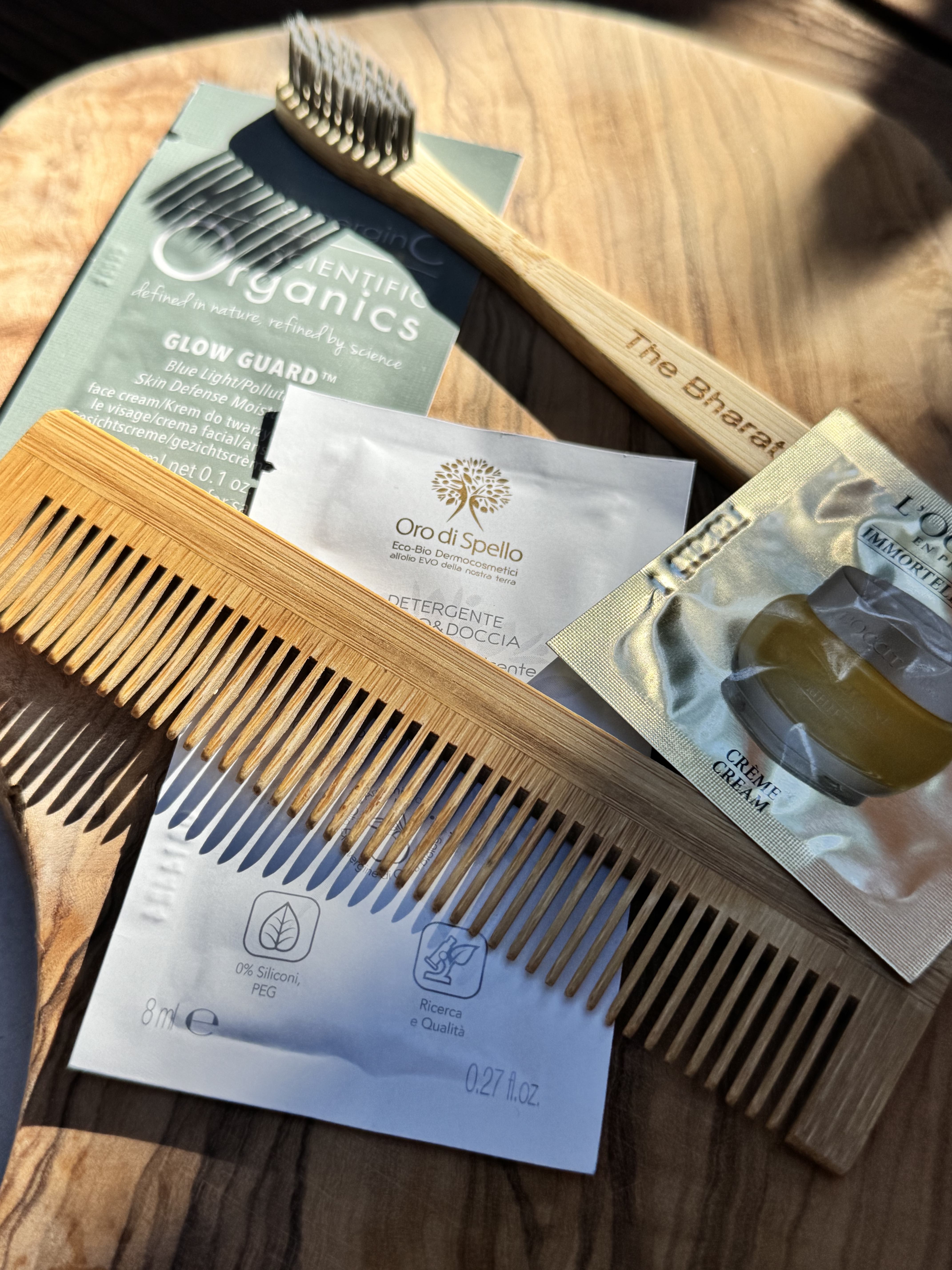 Luxury eco-friendly travel kit with bamboo toothbrush, wooden comb, organic skincare products and sustainable travel essentials